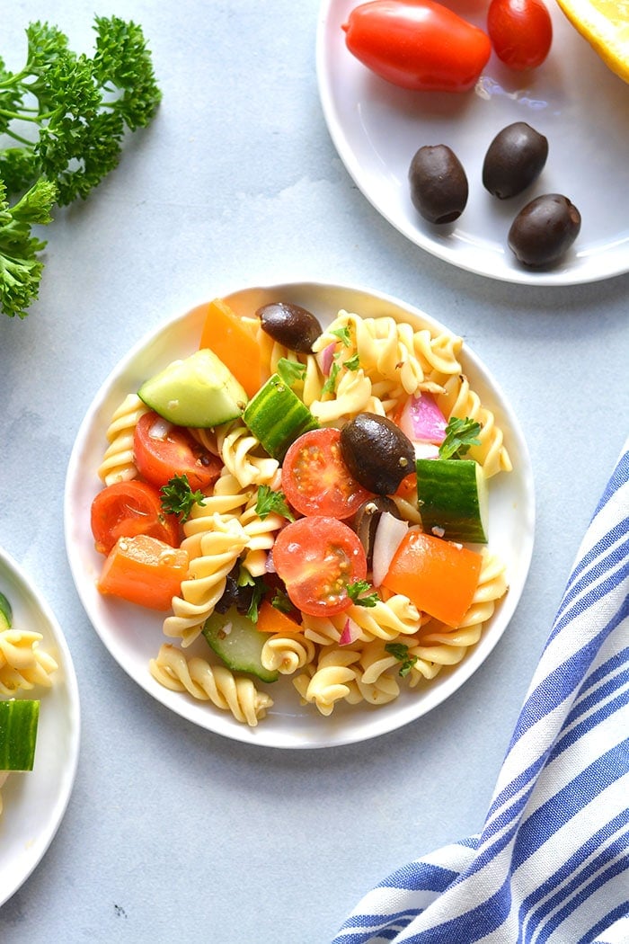 This Low Calorie Pasta Salad is loaded with vegetables and chickpea pasta. Made light with healthy ingredients this tasty, gluten free and dairy free pasta salad recipe is one you will make time and again. Perfect for summer eating as a side dish or appetizer!