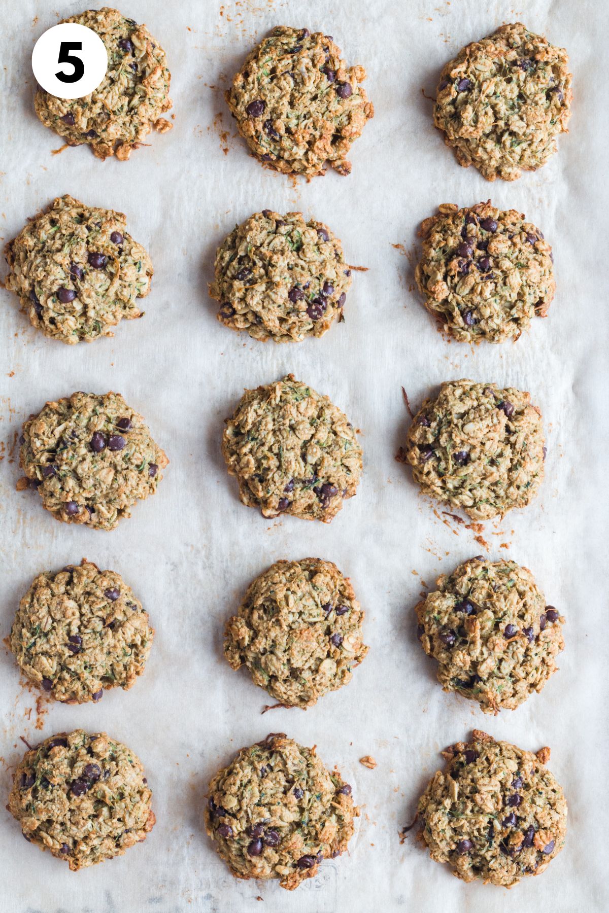 Baked zucchini chocolate chip cookies on a baking pan.