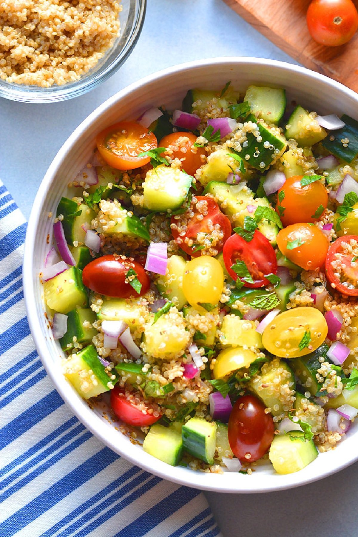 white bowl of tomatoes and quinoa.