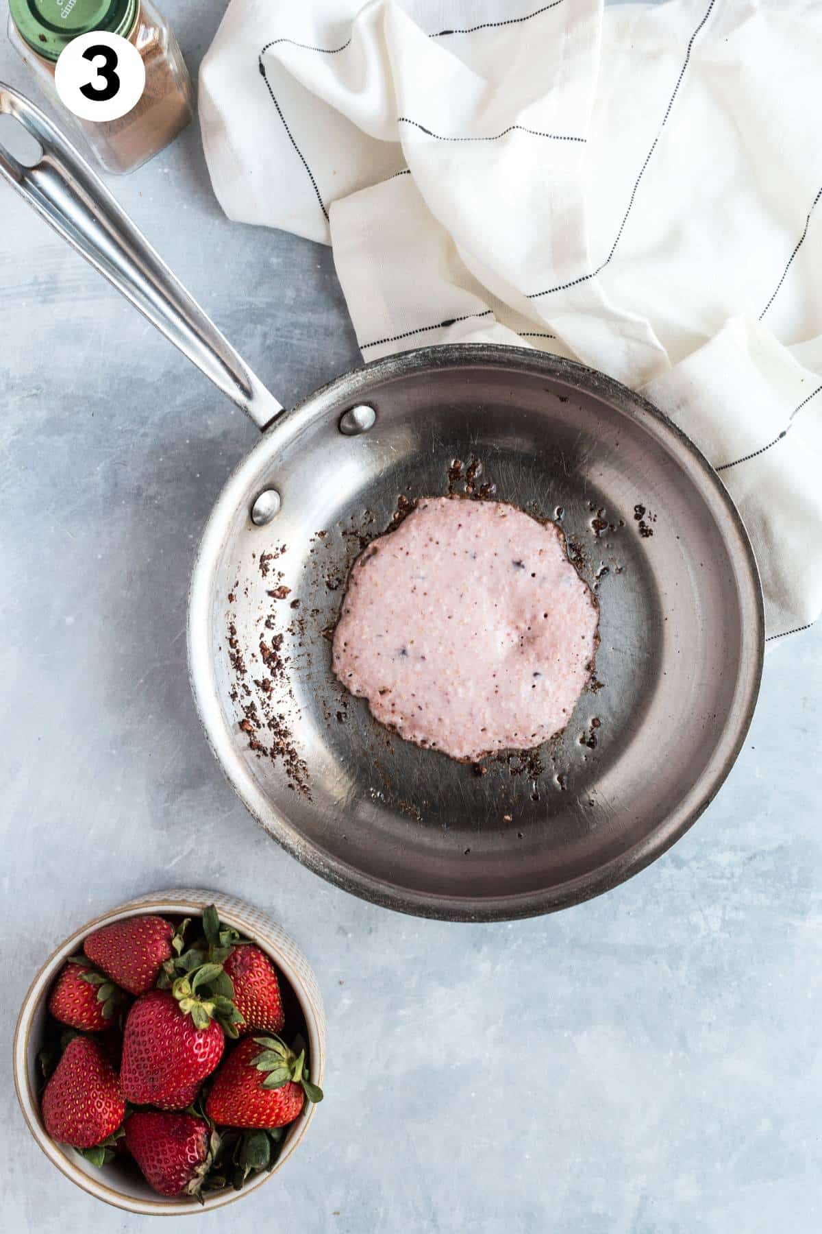 Pancake cooking in a skillet.
