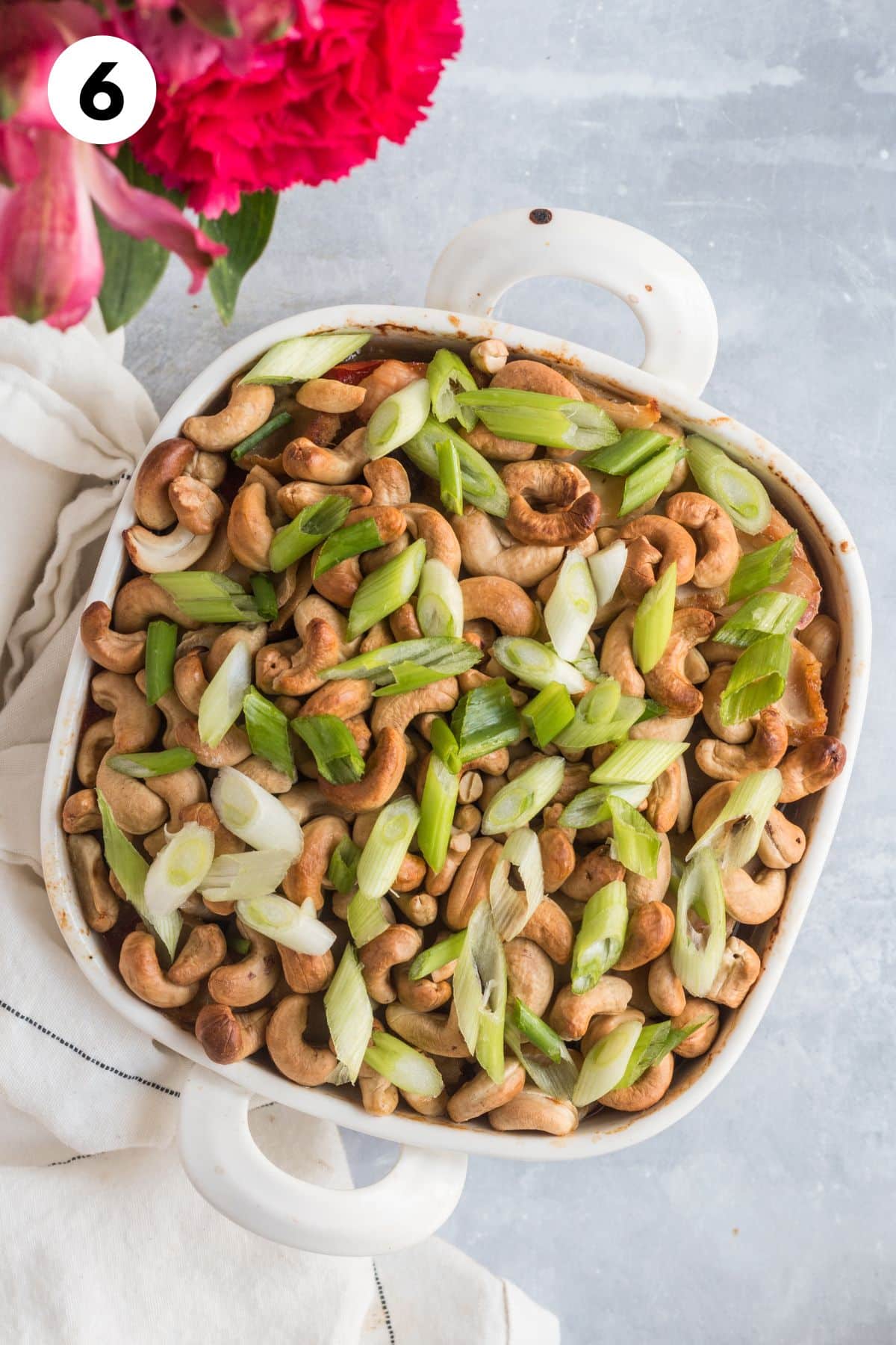 Baked cashew chicken casserole in a baking dish with cashews on top.