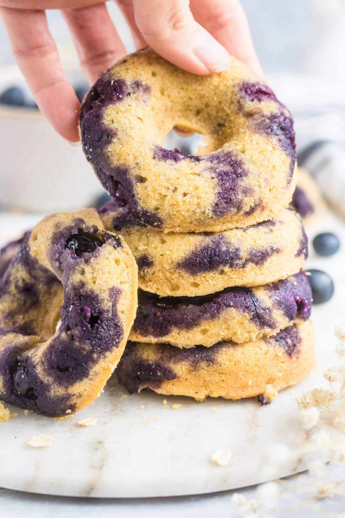 A stack of gluten free blueberry donuts.