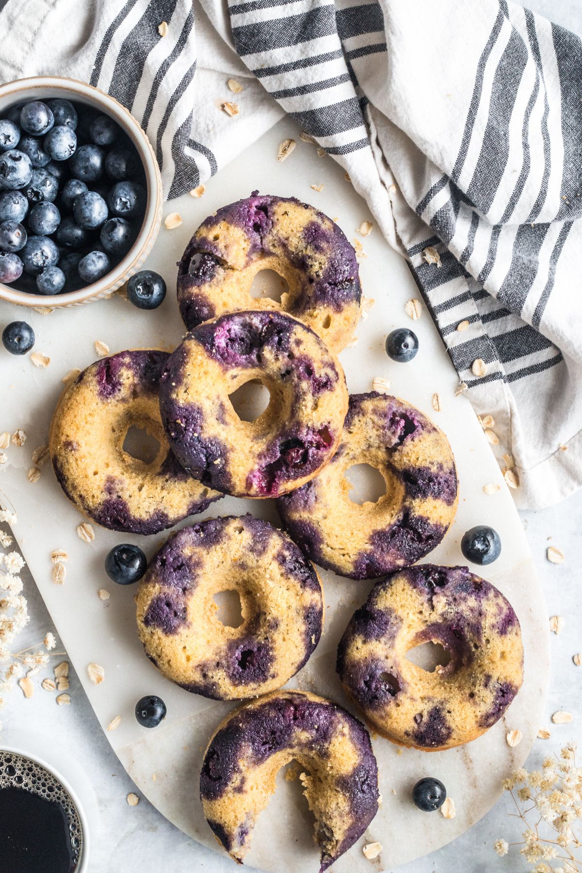 Gluten free blueberry donuts on a serving plate.