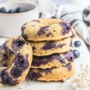 A stack of gluten free blueberry donuts.