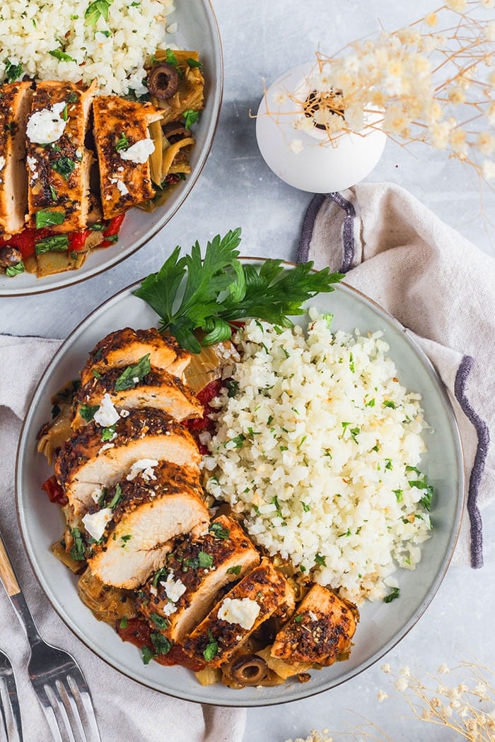 Healthy Greek Chicken Casserole is a low calorie, Mediterranean meal paired with vegetables and cauliflower rice. A gluten free recipe with Greek flavors that tastes amazing!