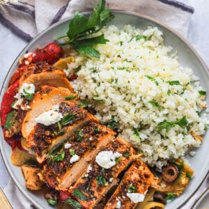 Healthy Greek Chicken Casserole is a low calorie, Mediterranean meal paired with vegetables and cauliflower rice. A gluten free recipe with Greek flavors that tastes amazing!