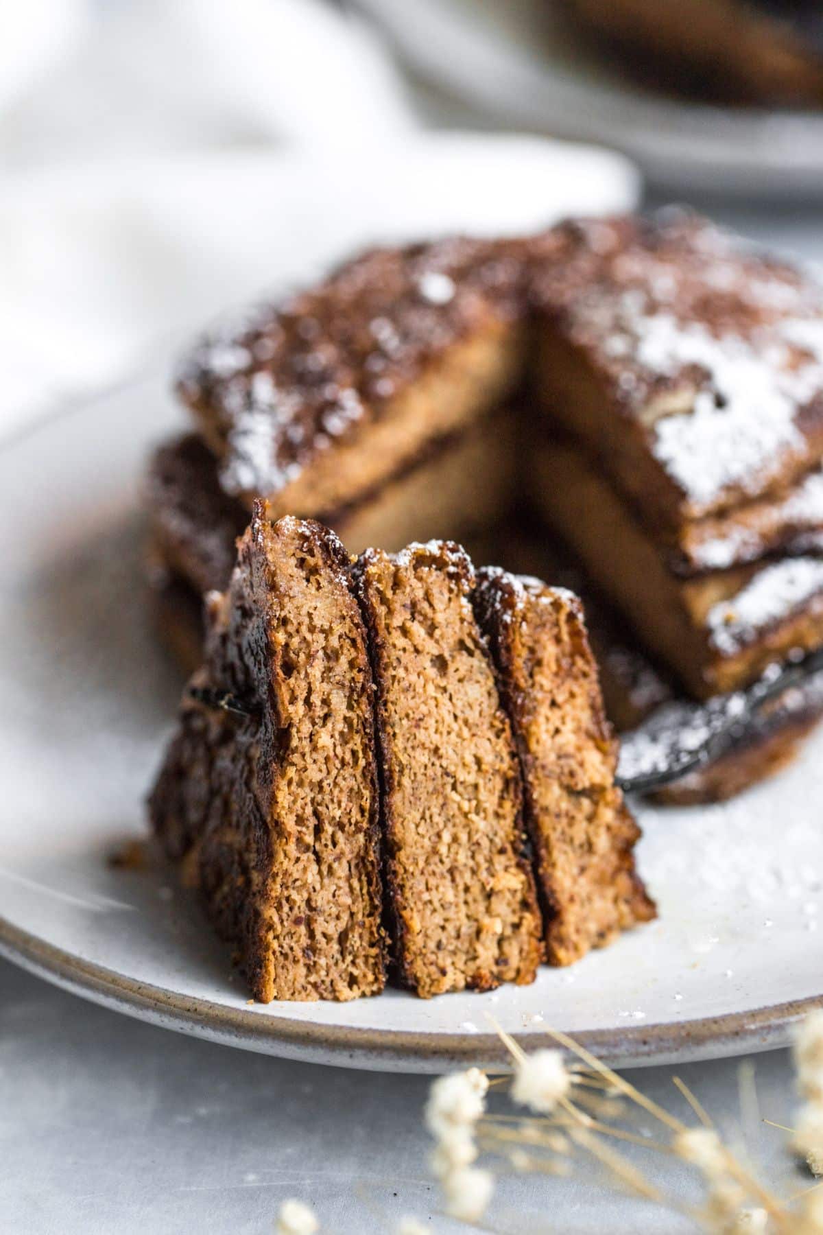 A stack of gluten free pumpkin with a slice taken out.