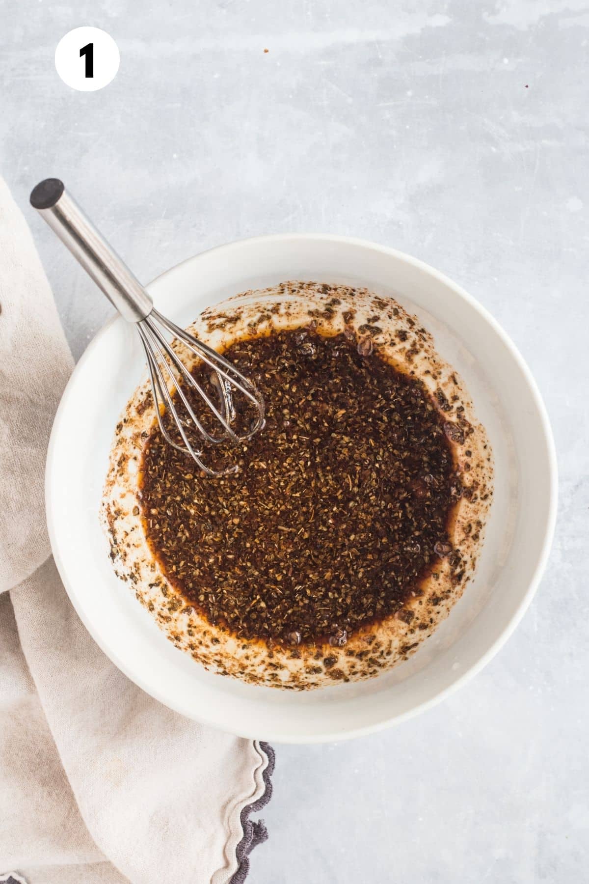 The marinade for greek chicken casserole in a bowl.
