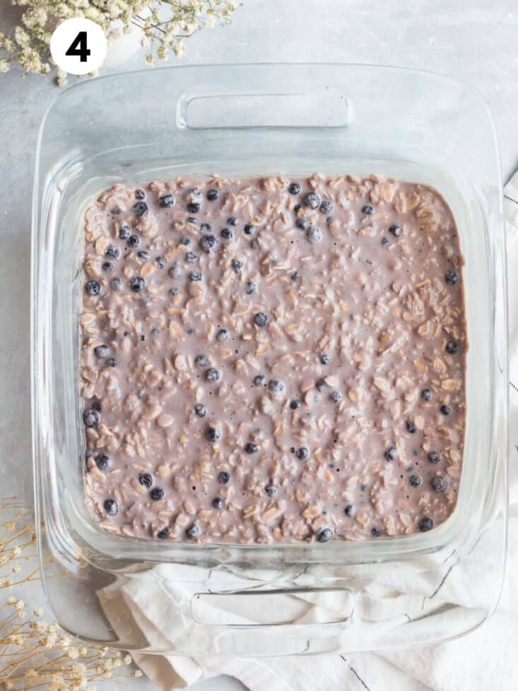 Oatmeal mixture added to a glass baking dish.