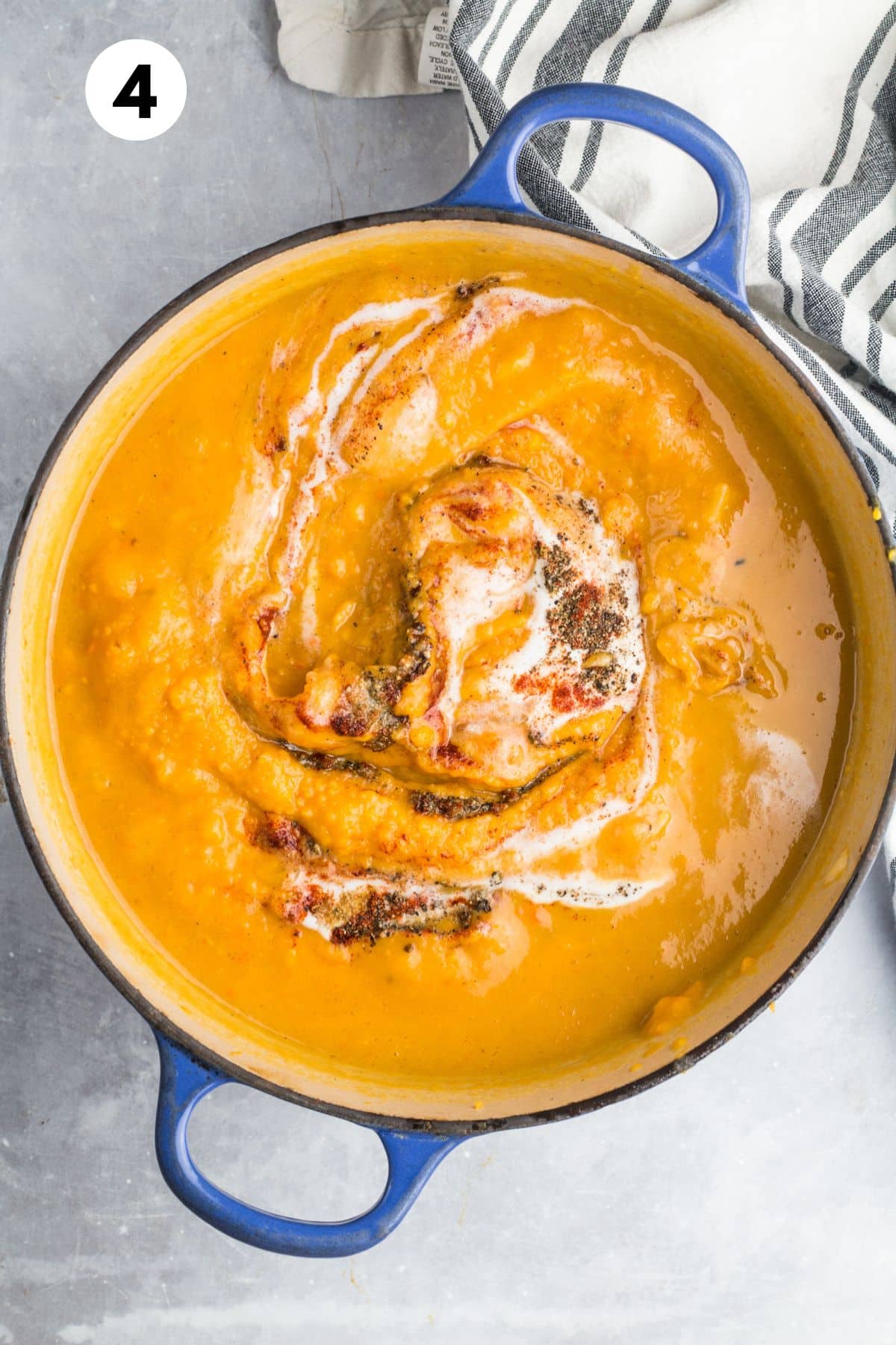 Cooked butternut squash and sweet potato soup in a pot.