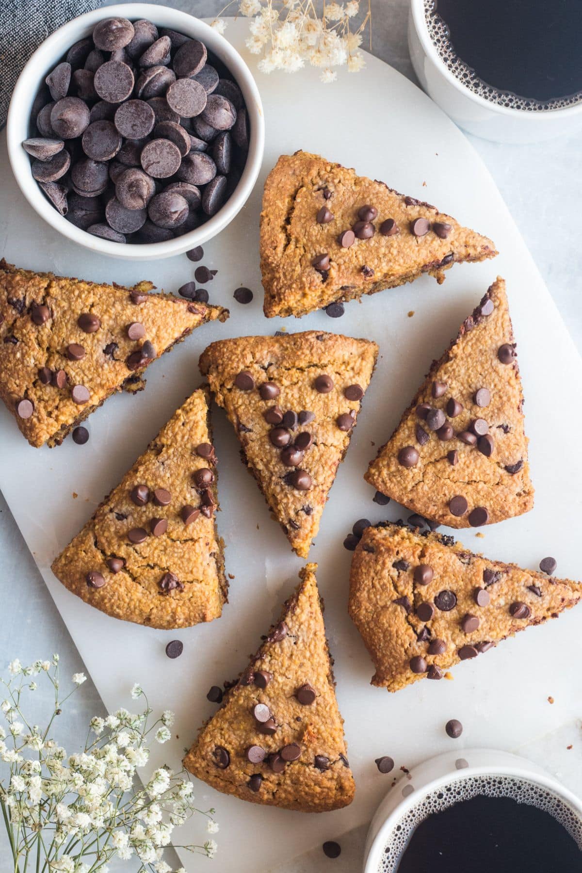 Gluten free pumpkin scones with a small dish of chocolate chips.