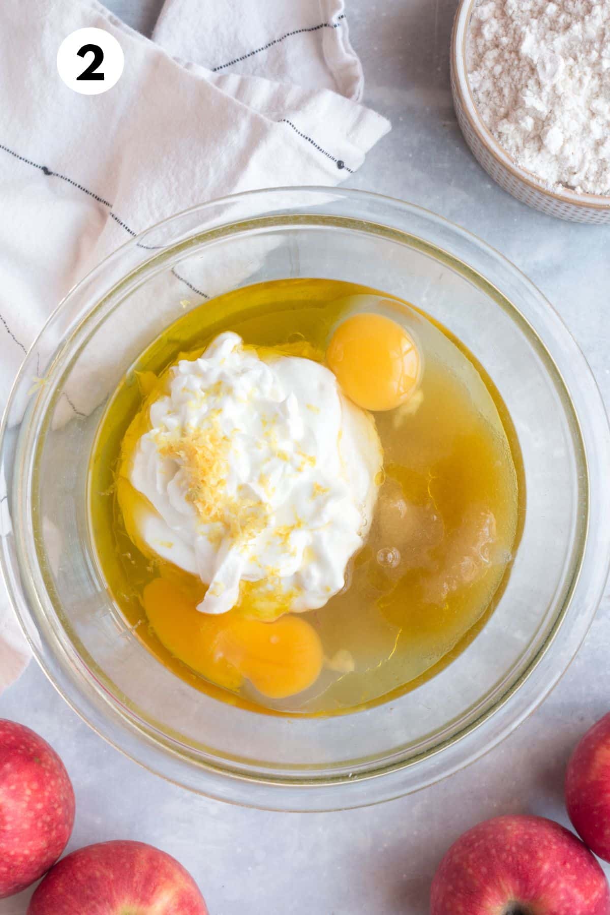 Wet ingredients for making Greek yogurt cake in a mixing bowl.