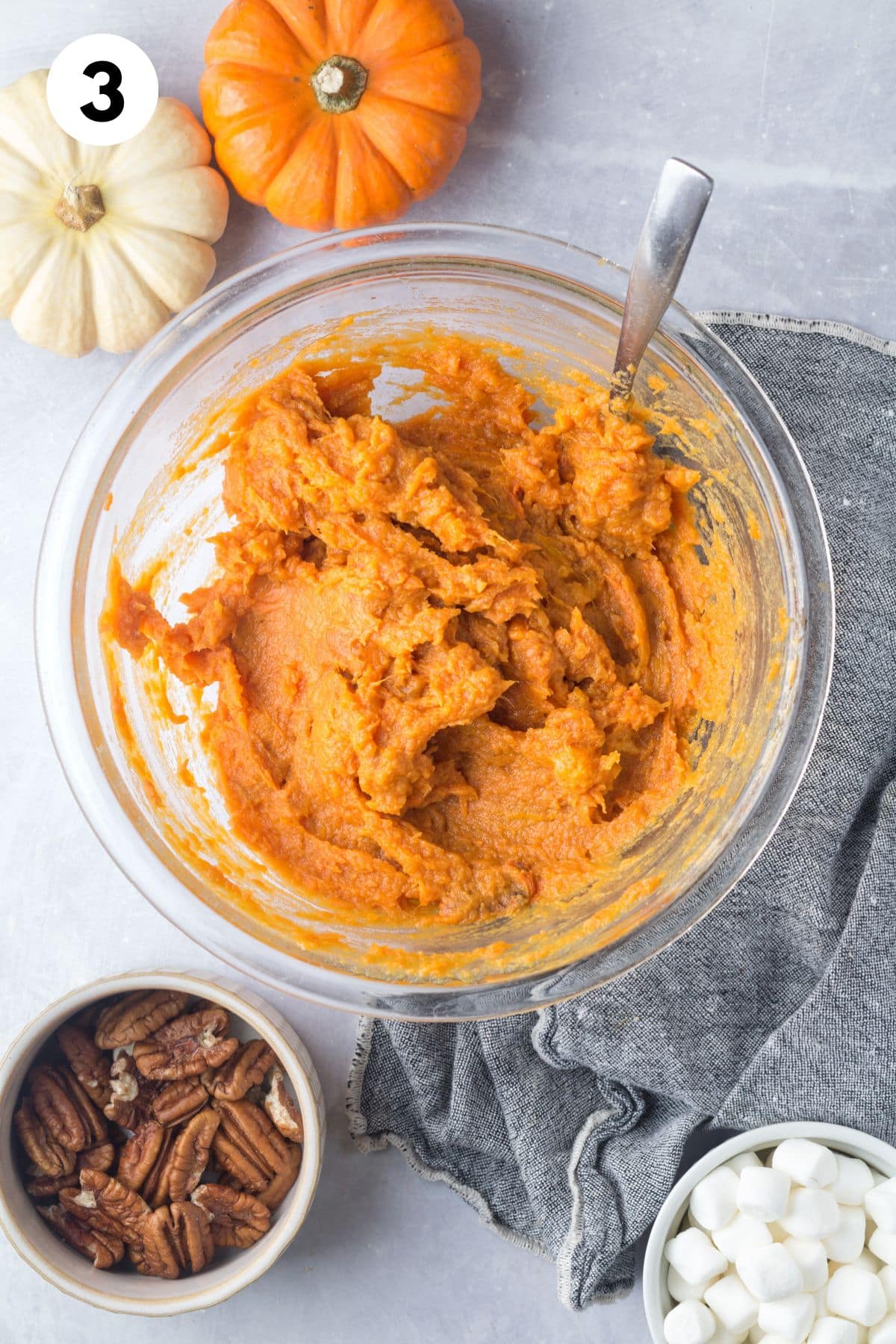 Mashed sweet potatoes in a glass bowl.
