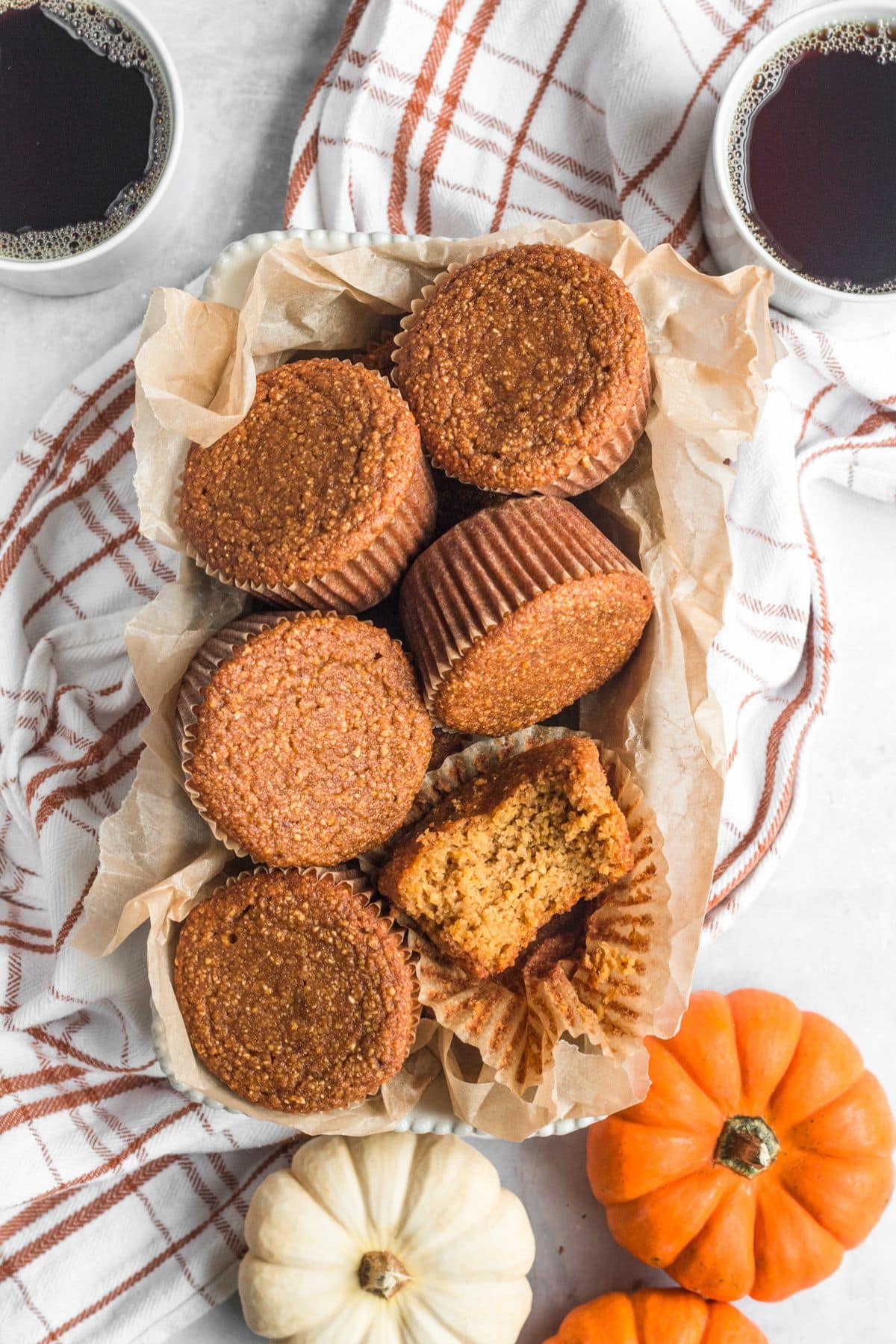 Pumpkin cornbread muffins on a towel.