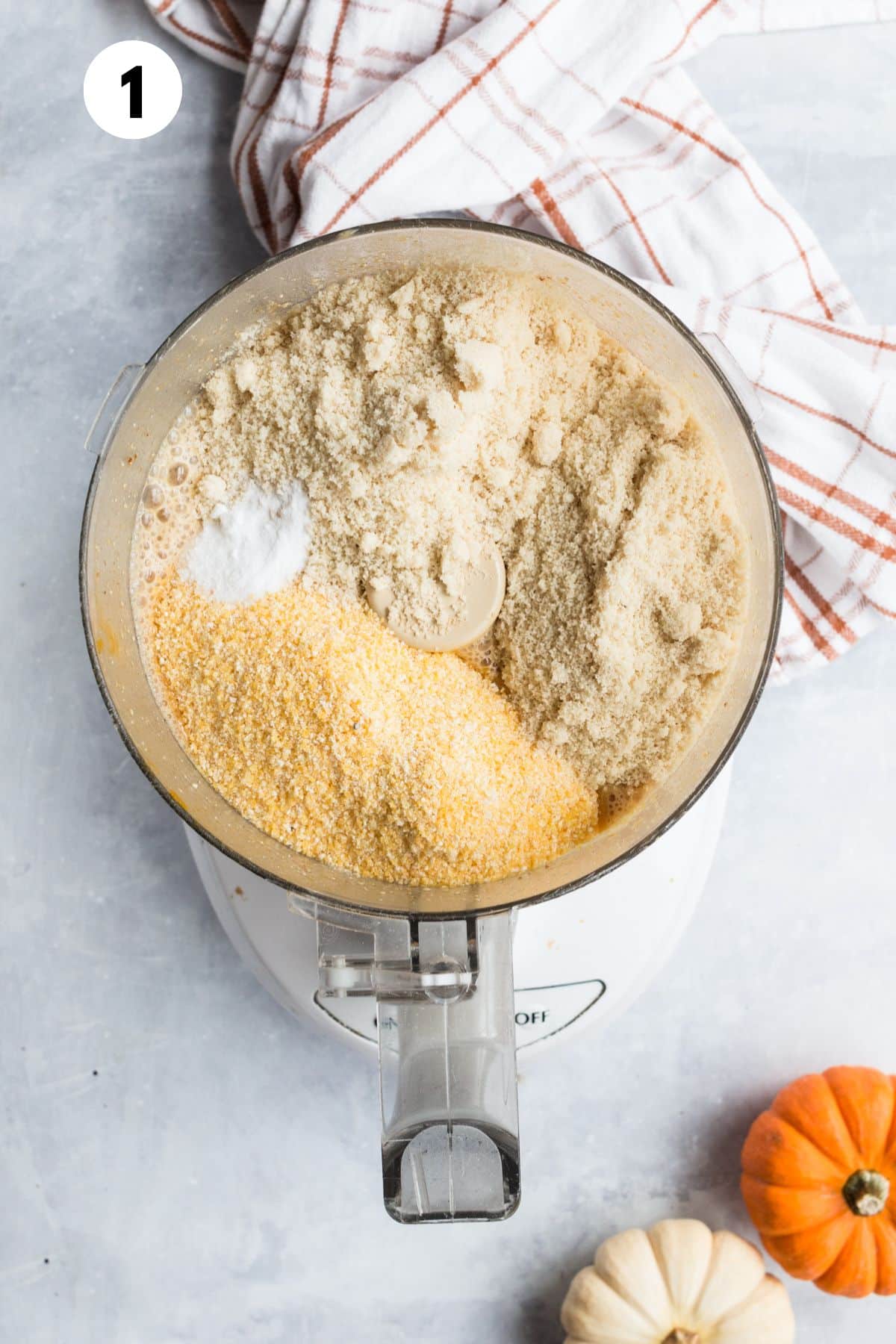 Ingredients for making pumpkin muffins mixed together in a food processor.