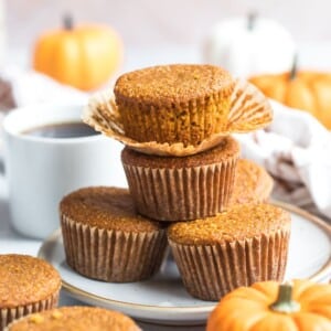 A stack of pumpkin cornbread muffins on a plate.