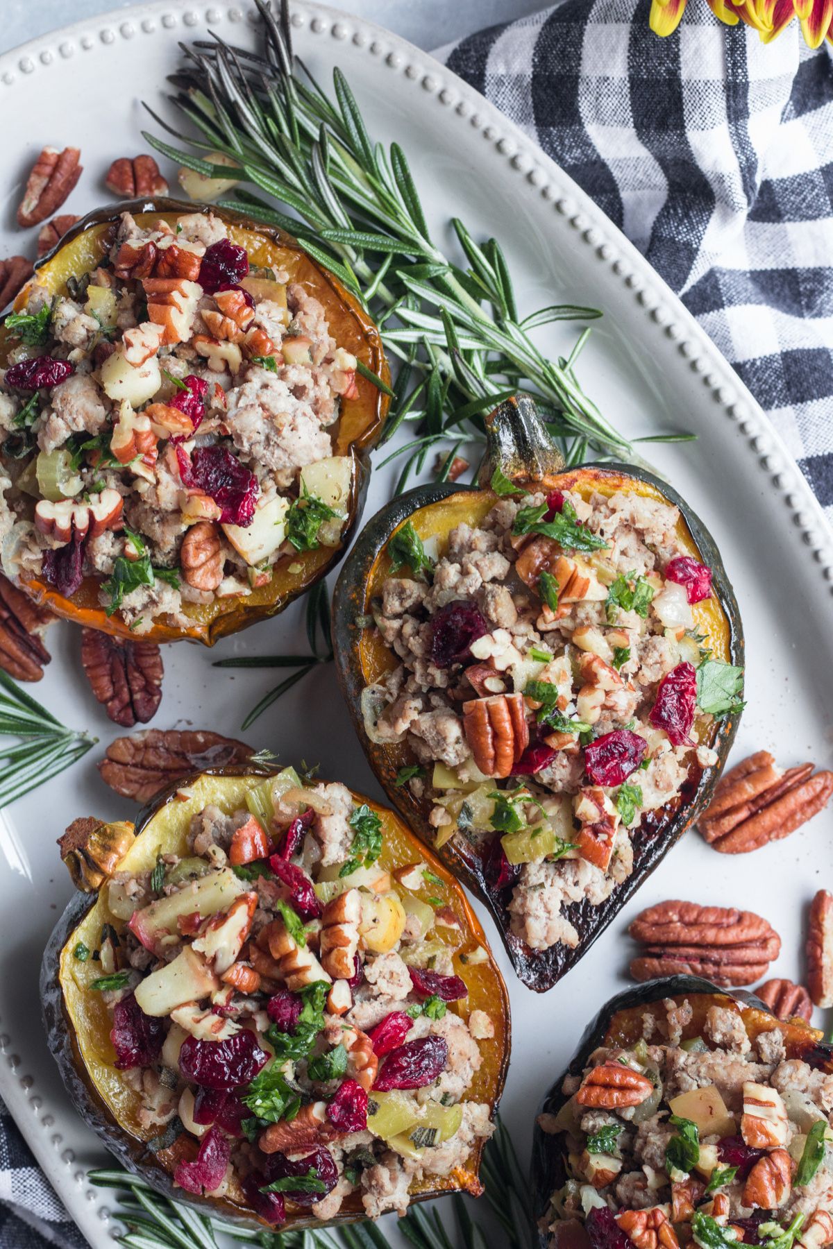 Turkey stuffed acorn squash on a serving dish.