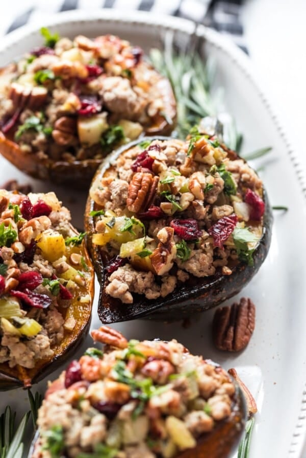 Turkey stuffed acorn squash on a serving dish.