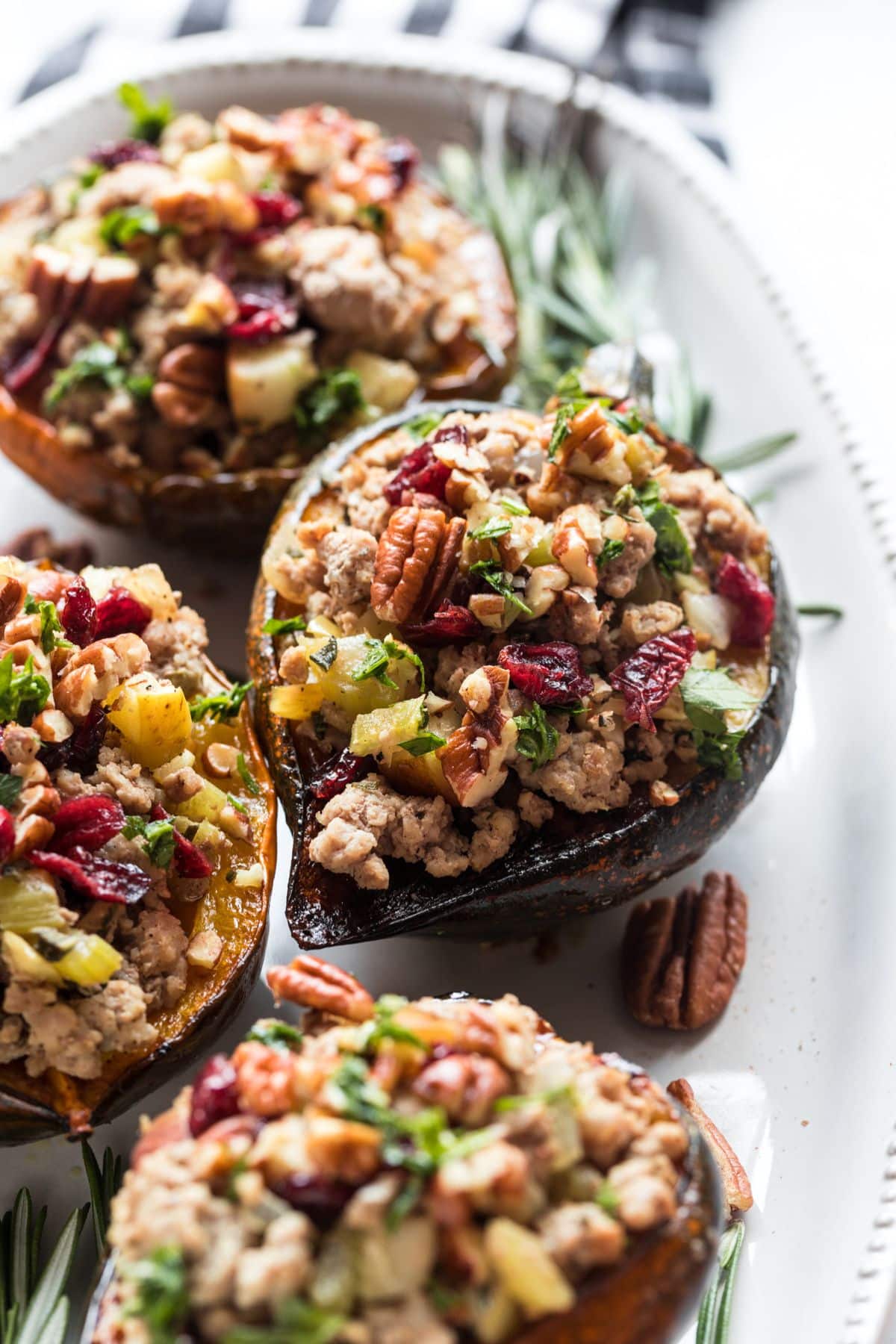 Turkey stuffed acorn squash on a serving dish.