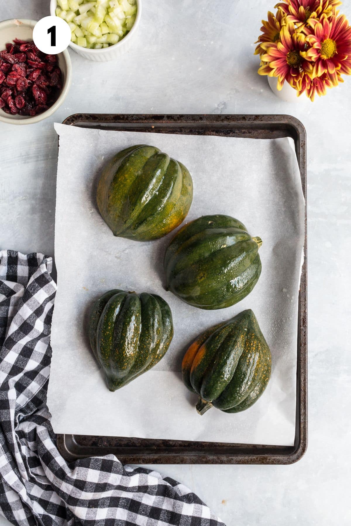 Cut acorn squash face down on a baking sheet.