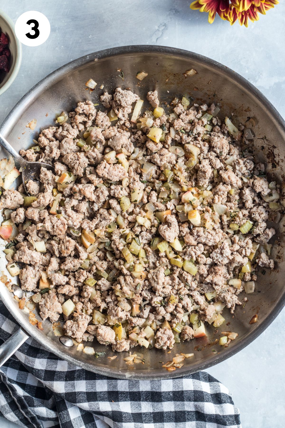 Ground turkey added to the aromatics in the skillet.