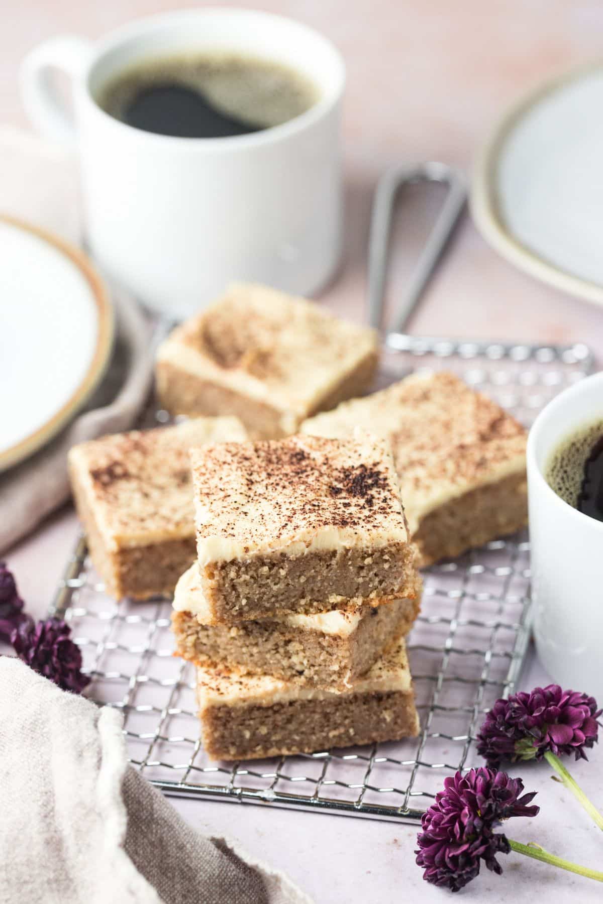 Pieces of gluten free gingerbread cake on a wire rack.
