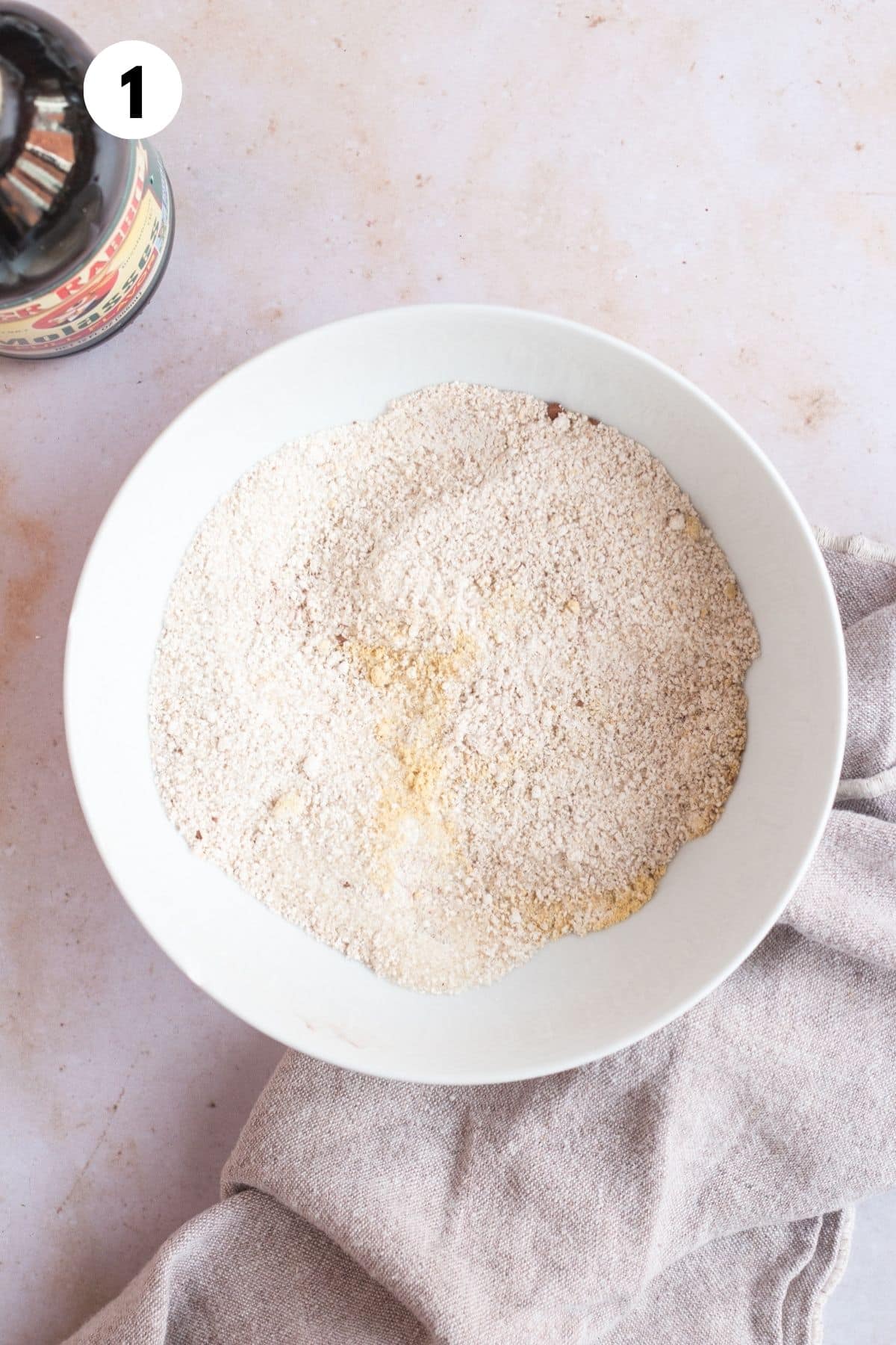 Dry ingredients for making gingerbread cake mixed in a bowl.