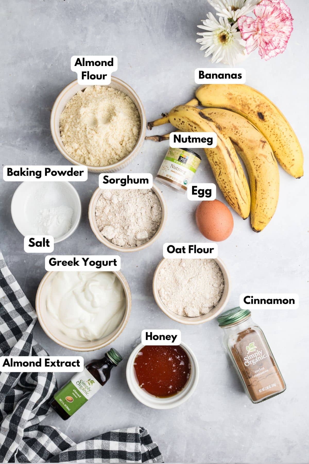 Ingredients to make banana muffins with almond flour on a table in bowls.