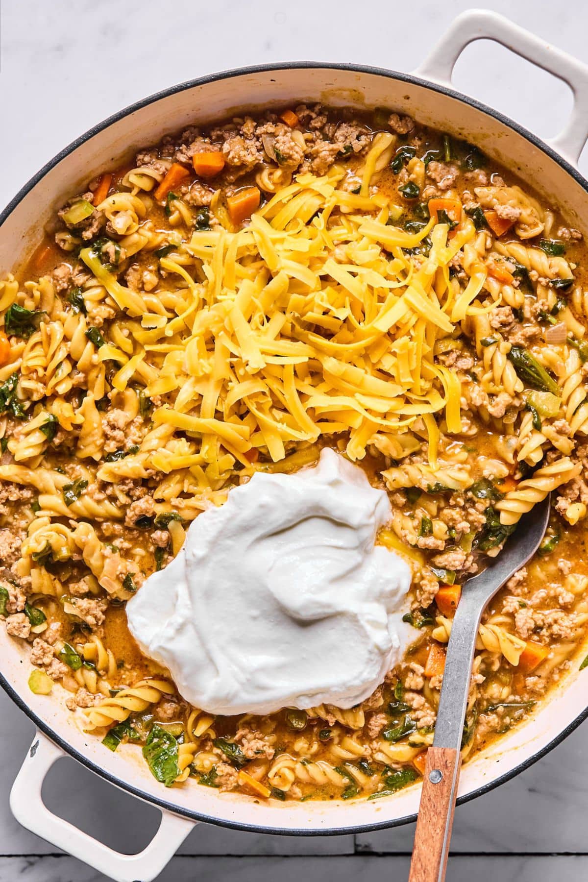 Yogurt and cheese added to the mixture in the pot.