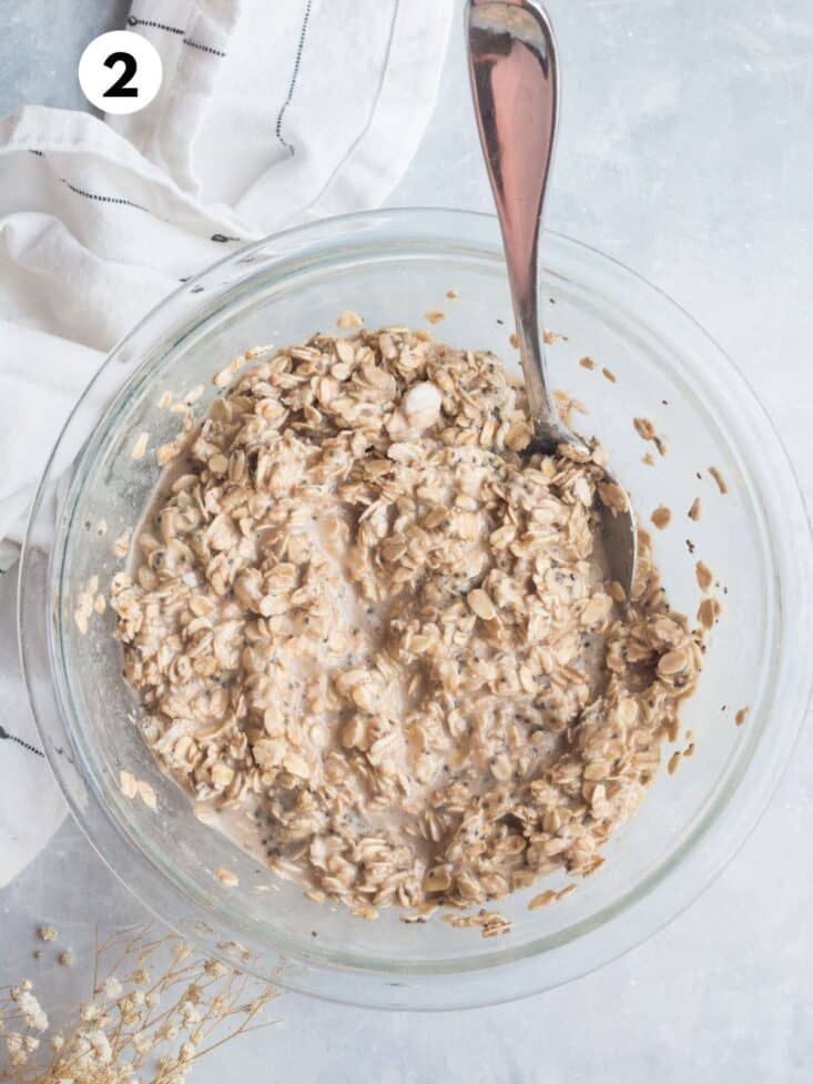 Protein oatmeal mixed in a bowl with a spoon resting on the side.