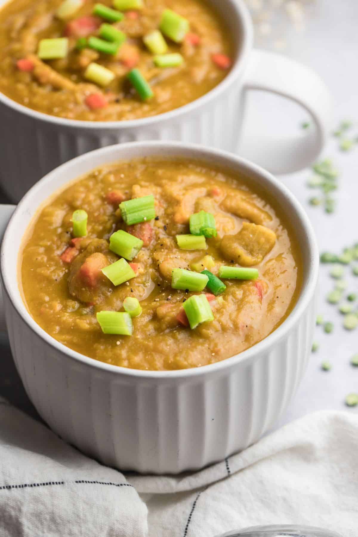 Two bowls of healthy split pea soup on a table. 