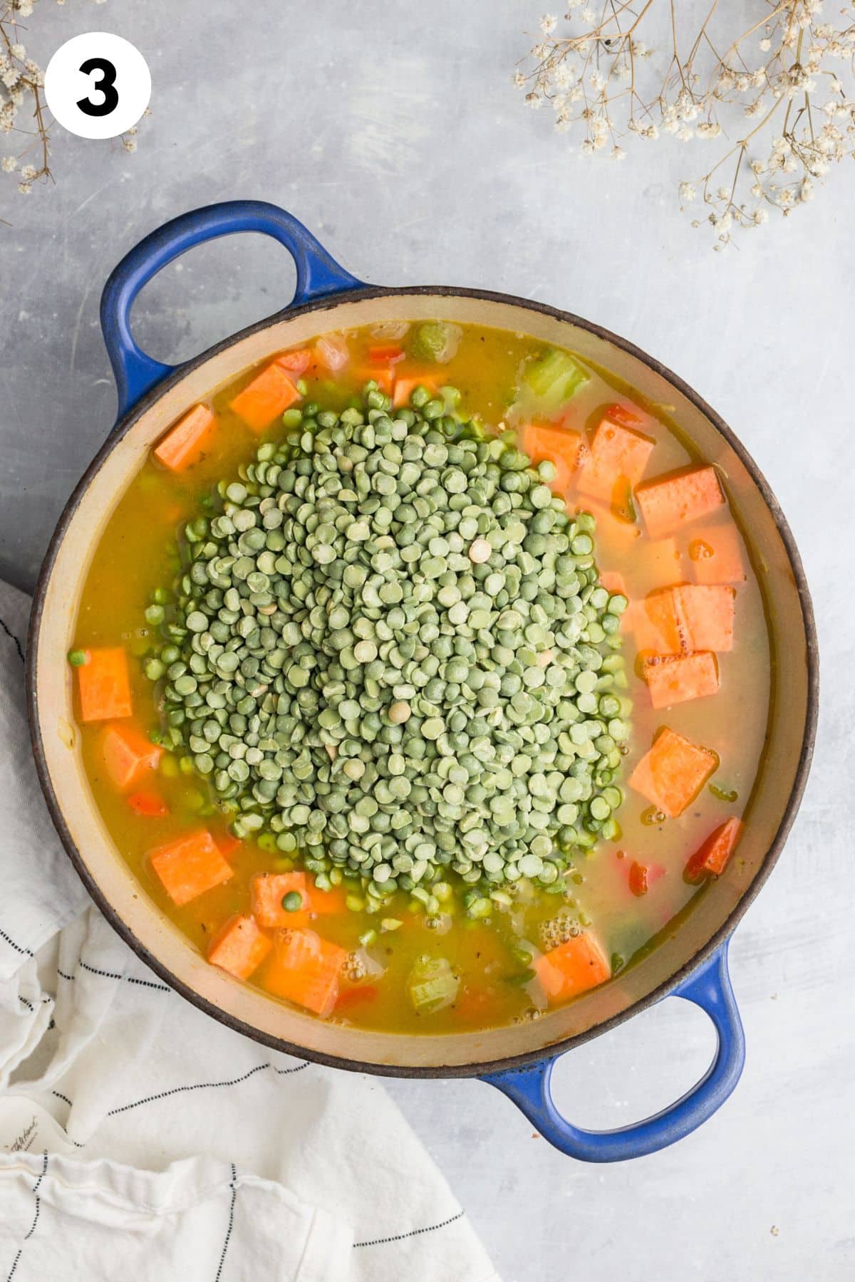 Broth and split peas added to the pot.