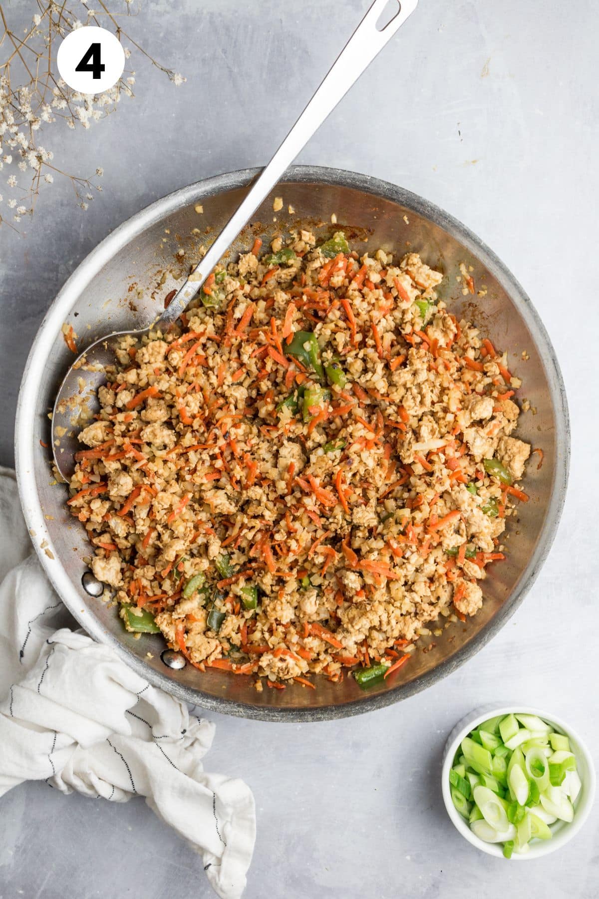 All the ingredients added to the skillet to make a healthy fried rice.