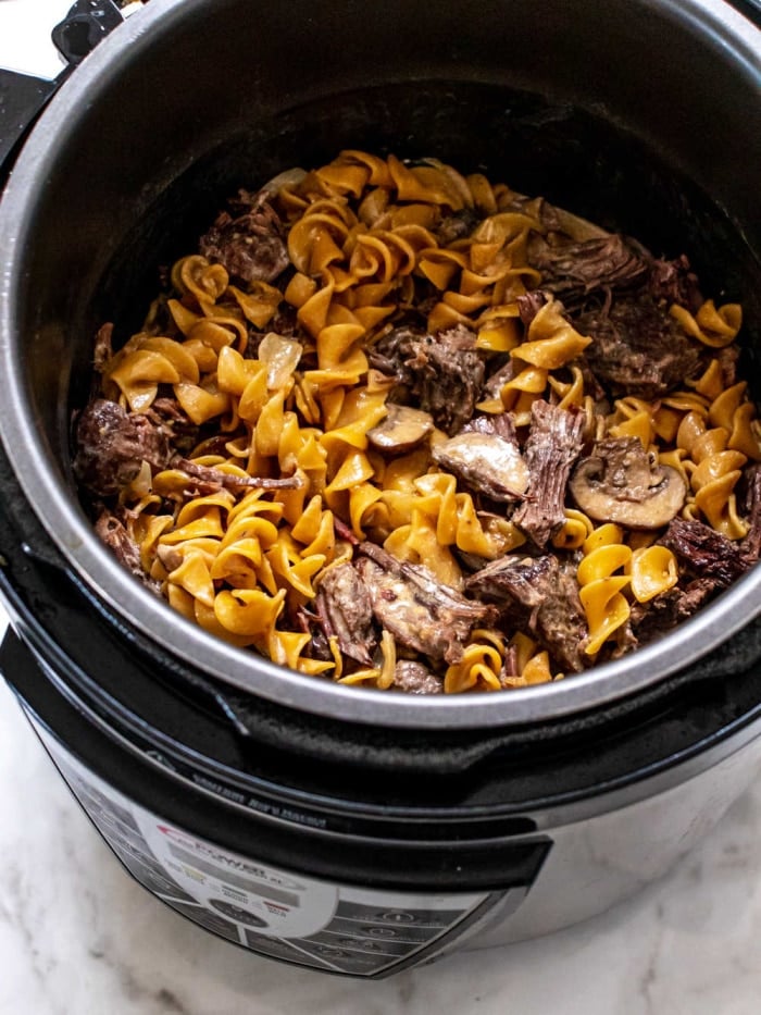 Healthy Beef Stroganoff made gluten free and calorie conscious! This easy dinner recipe is made in an Instant Pot for a healthy meal that can be made in a slow cooker too!
