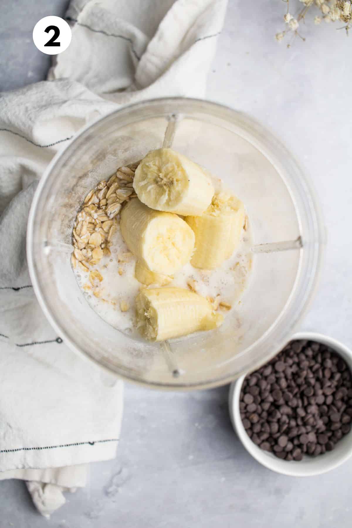 Banana, milk, oatmeal, and other ingredients in a blender.
