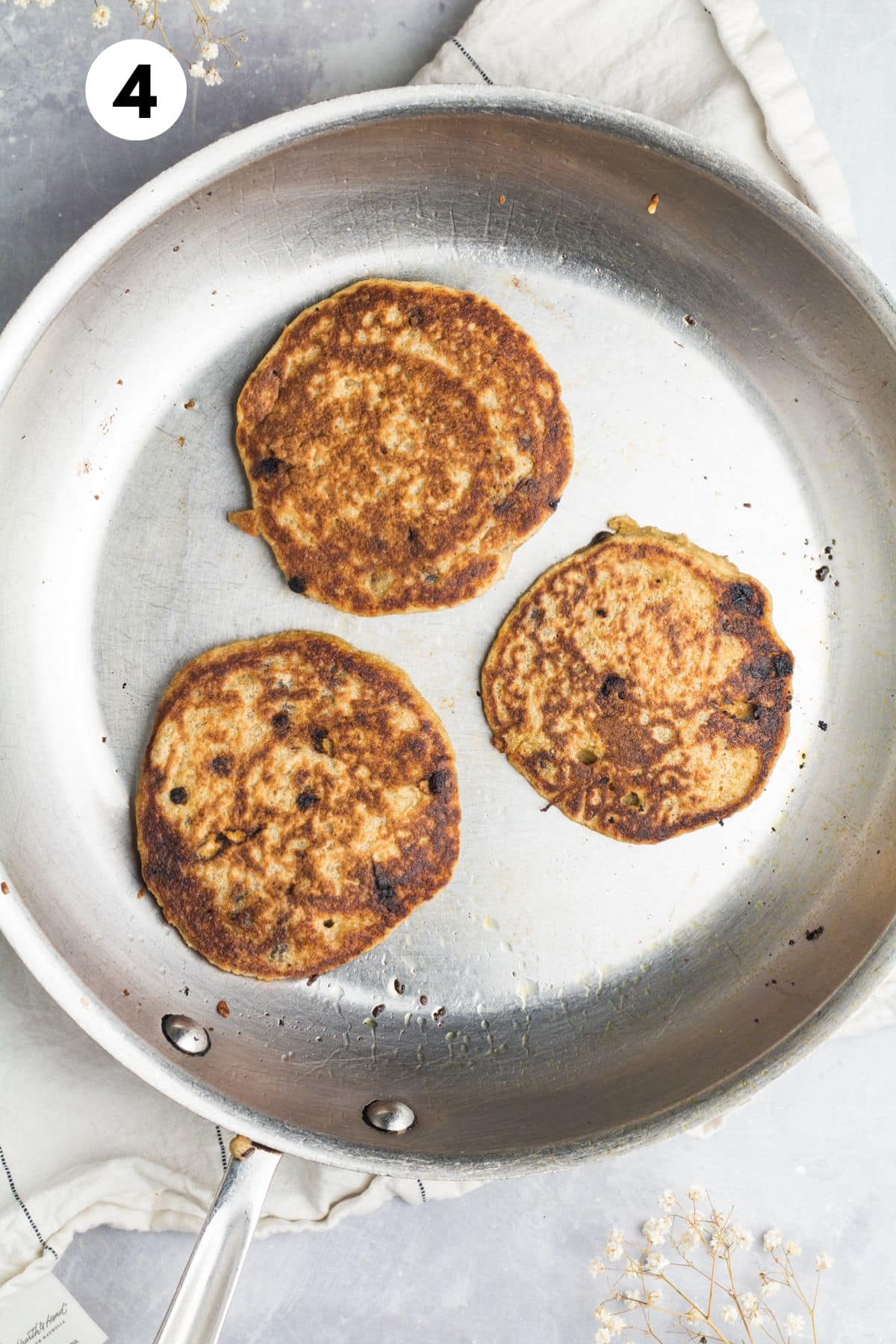 Pancakes cooking in a skillet.