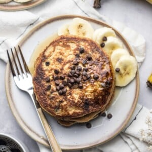 A stack of banana chocolate chip pancakes on a plate.