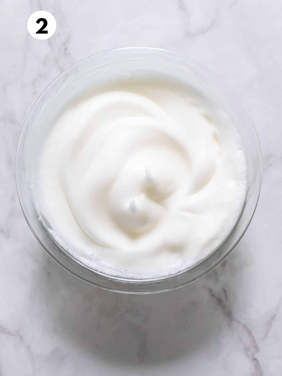 Whipped egg whites in a bowl. 