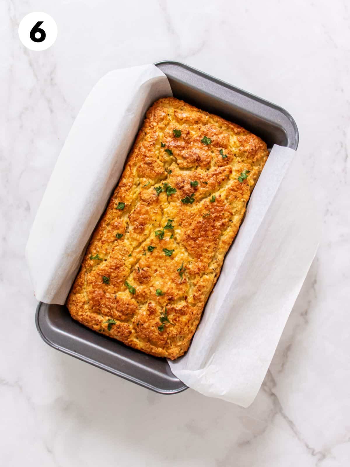 Cauliflower bread baked in a loaf pan.