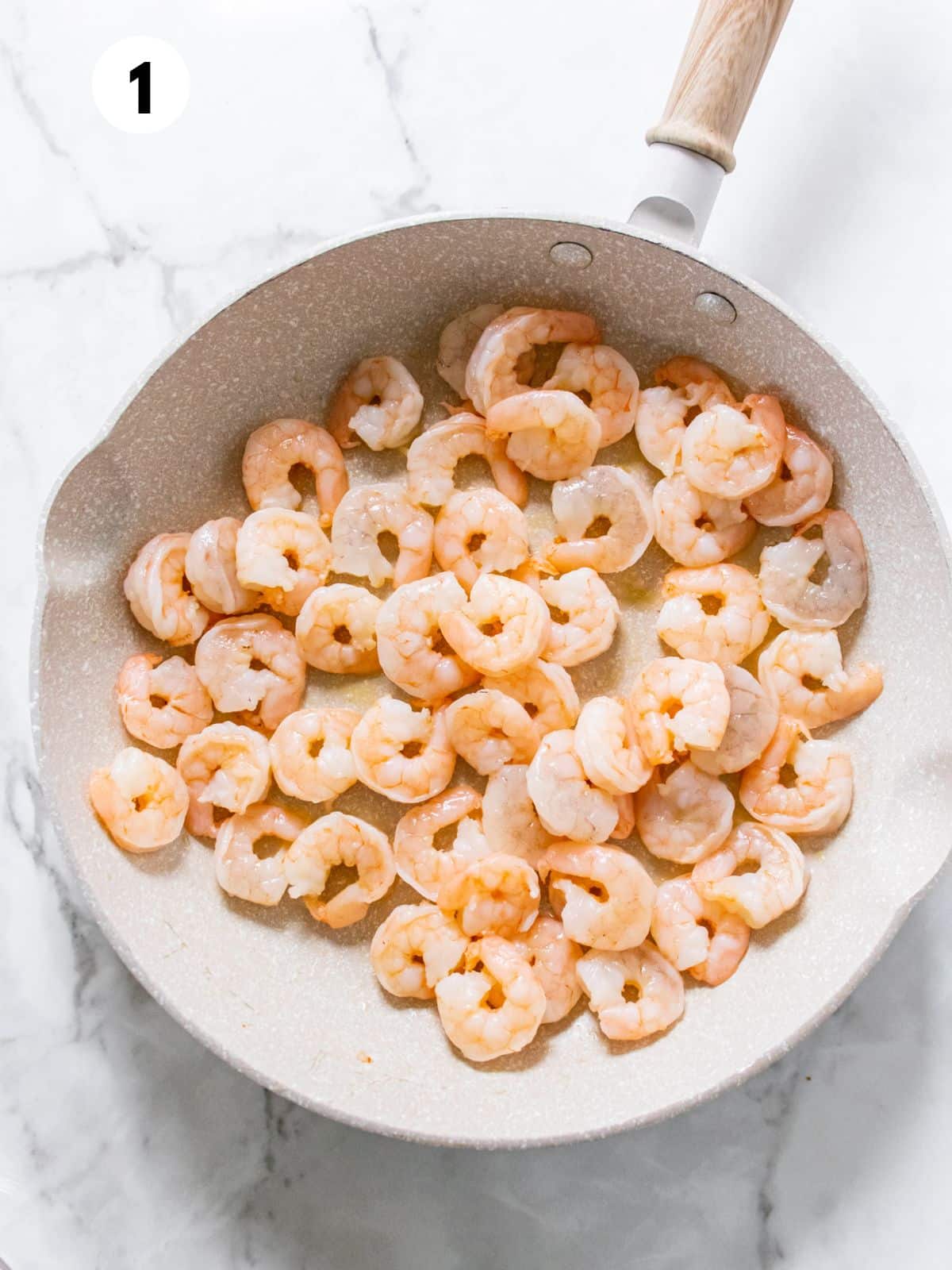 Shrimp cooking in a skillet.