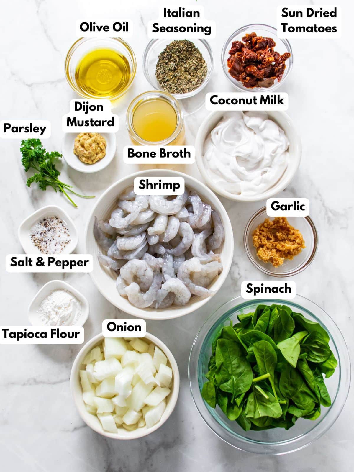 Ingredients to make Tuscan shrimp on the table with text labels. 