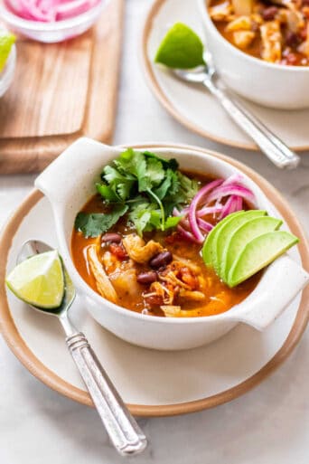 Healthy Chicken Tortilla Soup also known as Sopa Azteca is made low calorie and gluten free with simple ingredients, richly seasoned with a tomato and chile broth that is loaded with your favorite toppings.