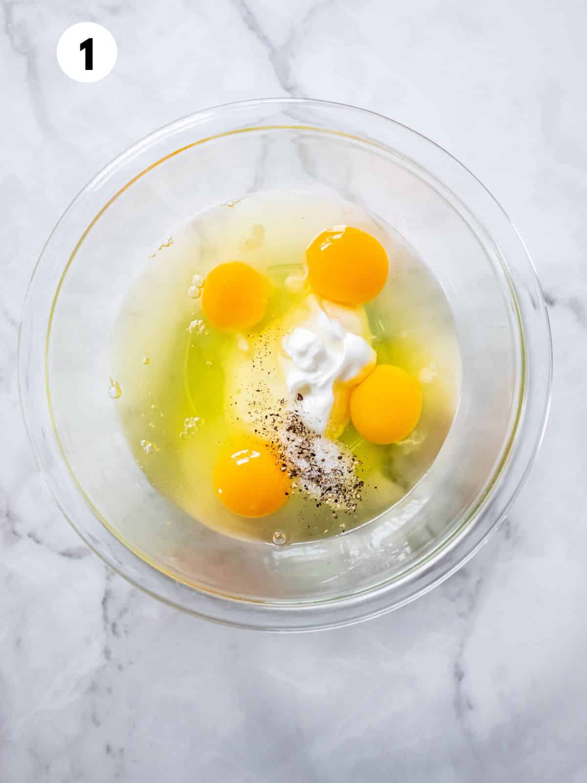 Eggs and yogurt in a mixing bowl.