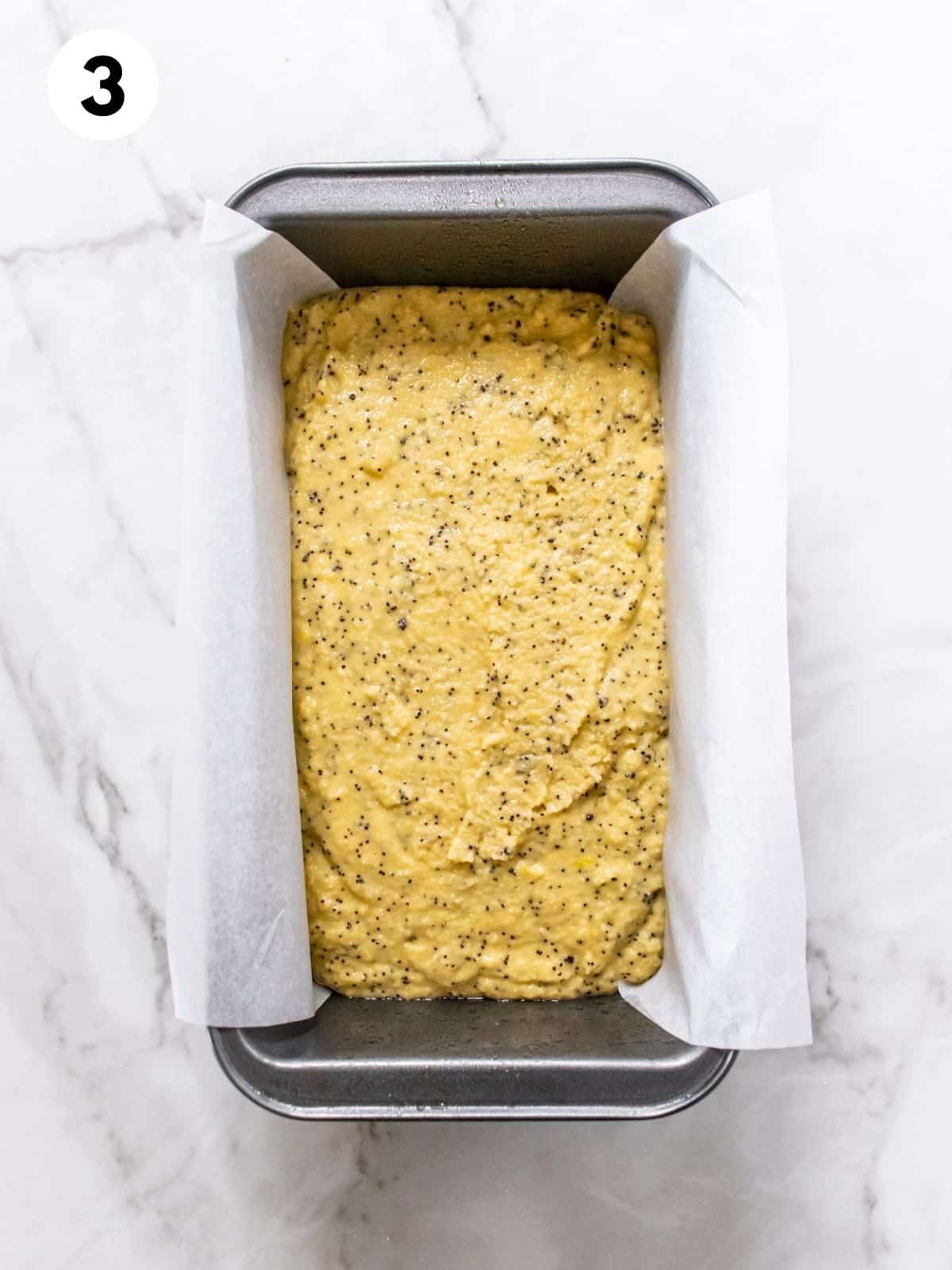 Lemon loaf batter poured into a loaf pan. 