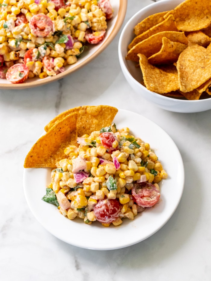 Healthy Greek Yogurt Mexican Street Corn Salad is a higher protein, creamy side salad made with spices that's lower in calorie and gluten free! Serve with sliced vegetables or chips for a healthy appetizer.