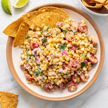 Healthy Greek Yogurt Mexican Street Corn Salad is a higher protein, creamy side salad made with spices that's lower in calorie and gluten free! Serve with sliced vegetables or chips for a healthy appetizer.