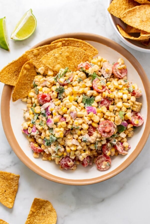 Healthy Greek Yogurt Mexican Street Corn Salad is a higher protein, creamy side salad made with spices that's lower in calorie and gluten free! Serve with sliced vegetables or chips for a healthy appetizer.