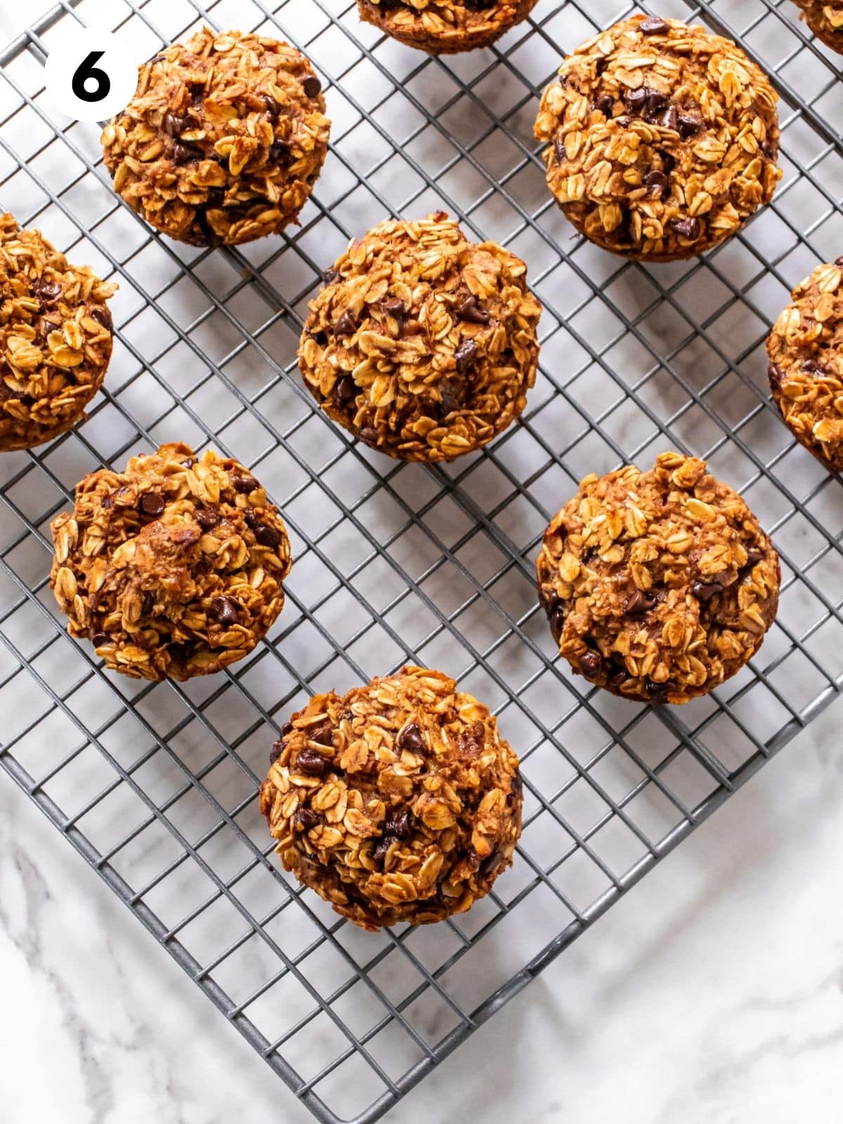 Peanut banana muffins sitting on a wire cooling rack.