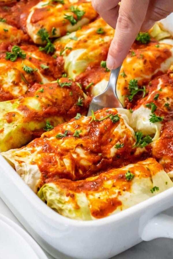 A spoon scooping up a serving of healthy cabbage rolls casserole.