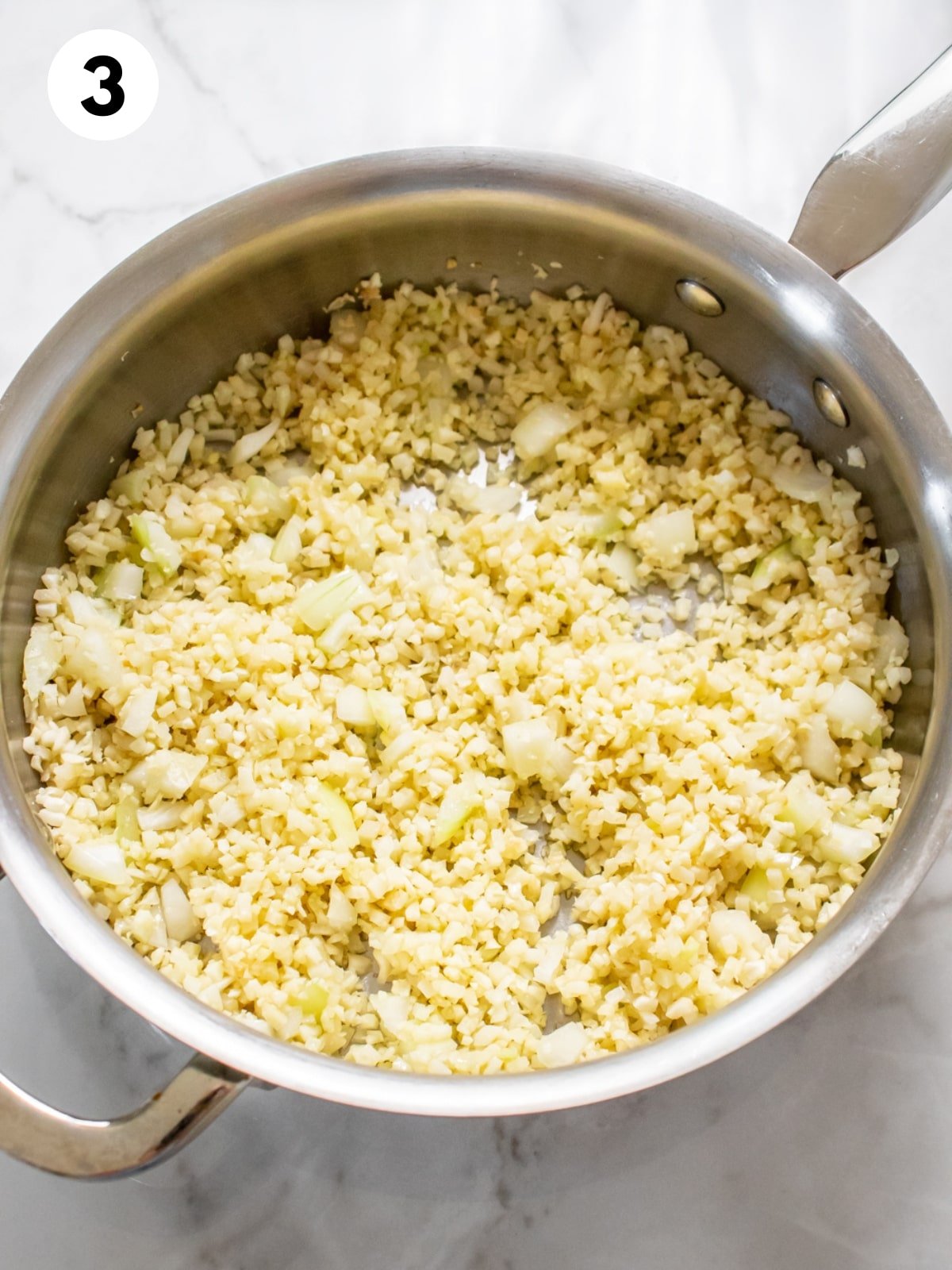 Cauliflower rice cooked in a skillet.